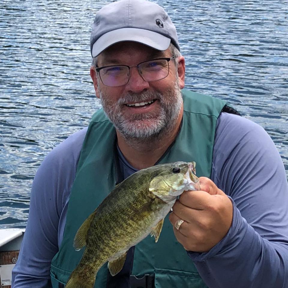 Kyle Rolph of Youth Unlimited YFC Elgin County holds a fish